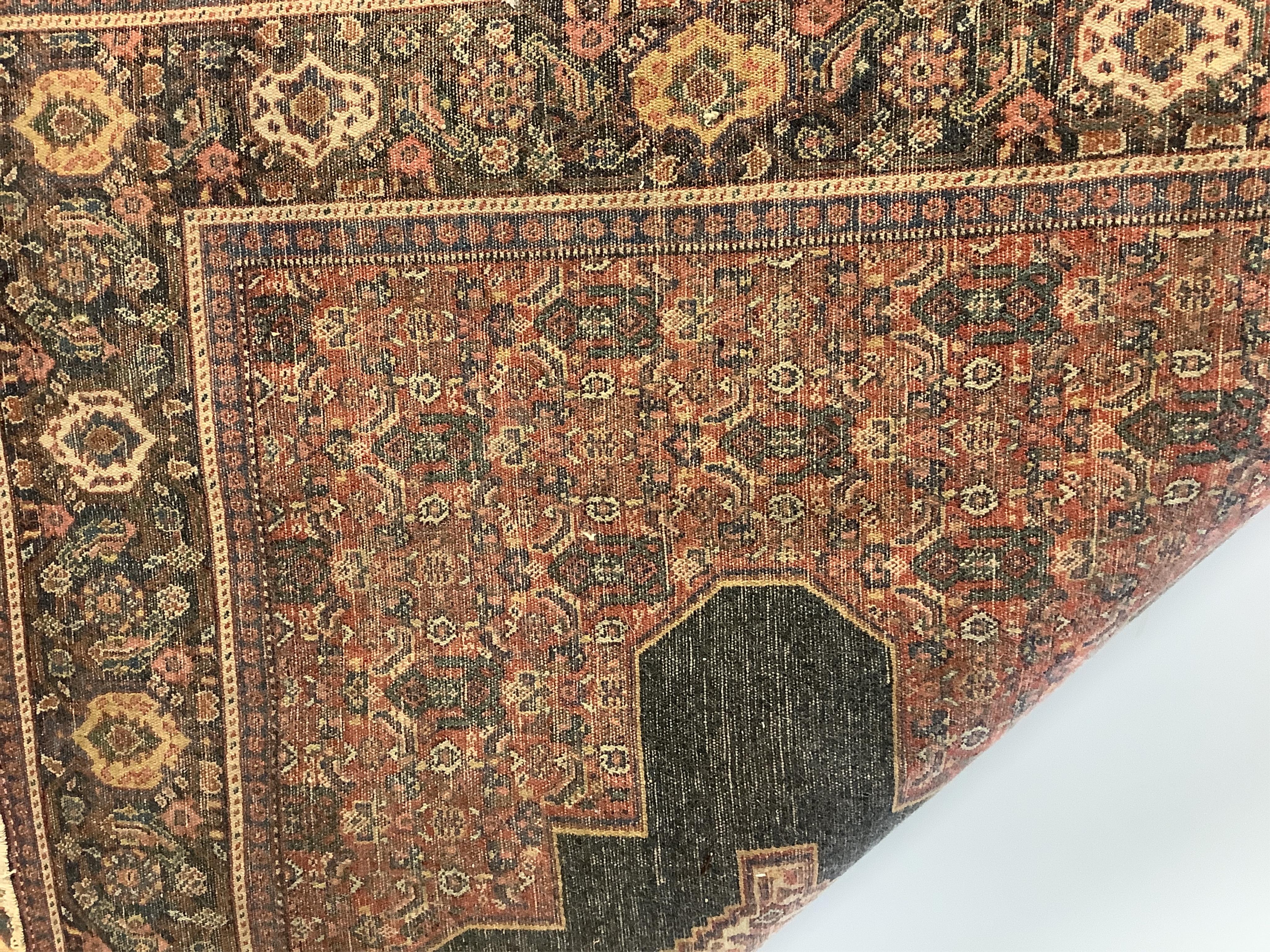 A Persian Senneh red ground rug, 186 x 138cm. Condition - fair to good